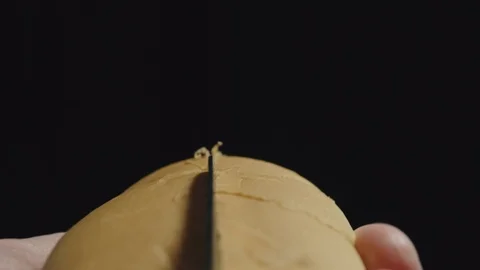 Sharp knife cuts white hot dog bread along. Man cooking. Close up. Stock Footage 126567070