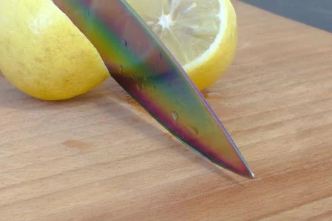Sharp knife cuts yellow lemon Stock Photos