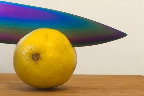 Sharp knife cuts yellow lemon Stock Photos
