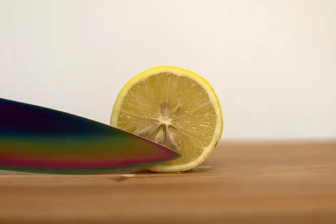 Sharp knife cuts yellow lemon Stock Photos