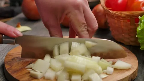 A sharp knife cutting a fresh onion into pieces closeup Stock-Footage 312795586