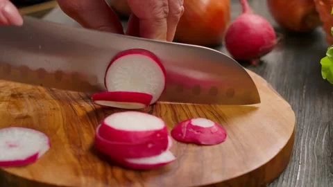 Sharp knife cutting fresh radish into thin rings closeup Stock Footage 311891961