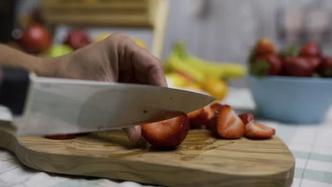 Sharp knife cutting through beautiful strawberry on cutting board in slow motion Stock Footage 341272117