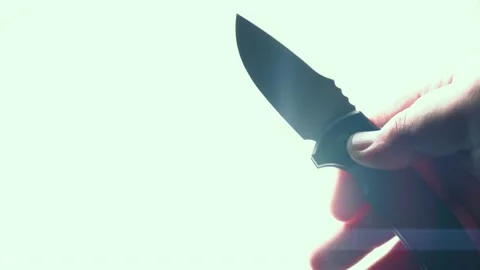 Sharp knife in male hand. EDC automatic folding pocket knife opening blade on Stock Footage 168211745