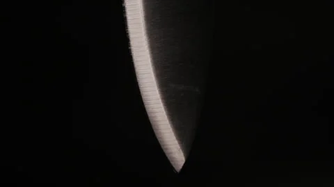 Sharp knife revealed when shining isolated on black background. Stock Footage 248301917