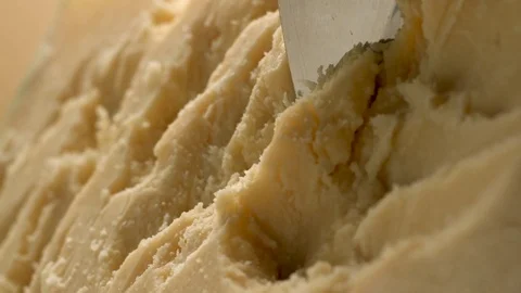 A sharp knife shreds hard cheese into small pieces. Stock Footage 83724354