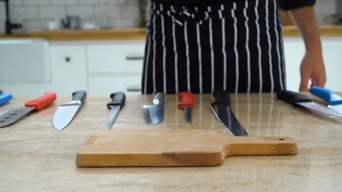 A sharp knife is stuck on a cutting board, ib01 Stock Footage 109125152