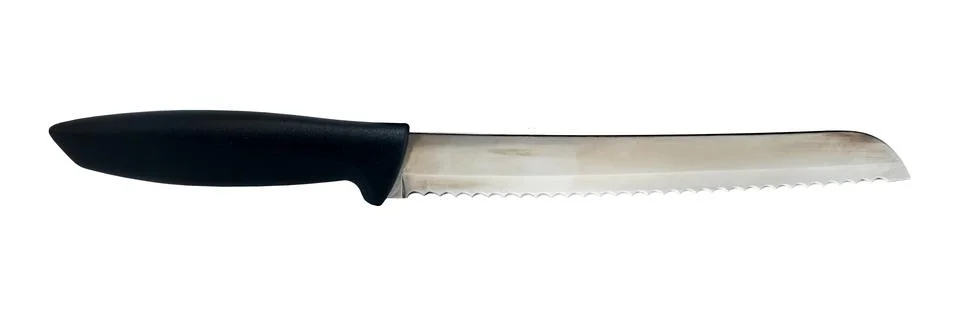 Sharp knife with teeth for cutting bread and bakery products on a white bac.. Foto stock