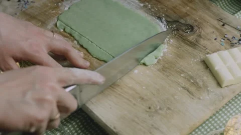 Sharp knife trimming the dough into clean straight edges Stock Footage 342128609