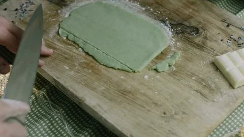 Sharp knife trimming the dough into clean straight edges Stock Photos