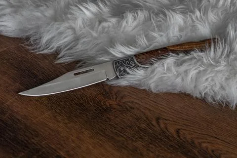 Sharp knife on white fur Stock Photos