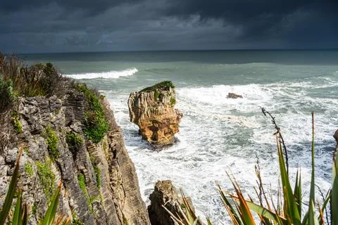 Sharp Limestone Cliffs with Isolated Sea Stack at Pancake Rocks, Punakaiki, Stock Photos