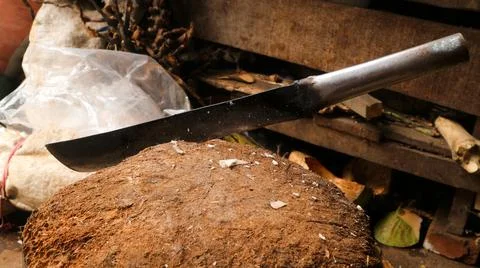 A sharp machete stuck in the wood Stock Photos