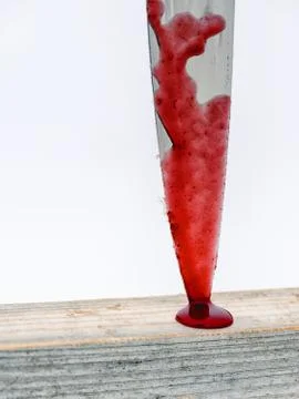 Sharp metal kitchen chopping knife stuck in wood with blood running down the  Stock Photos