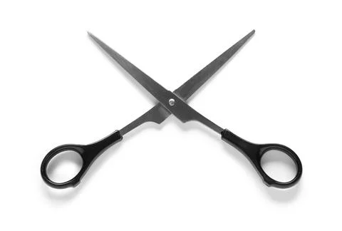 Sharp metal scissors with black plastic handles crossed on white background,  Stock Photos