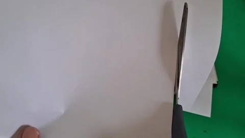 Sharp metal scissors cutting white paper in slow motion footage Vídeos de archivo 339335004