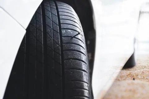 Sharp metal screw puncturing into a car tire Stock Photos