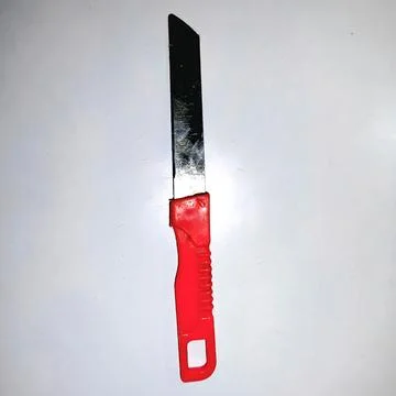 Sharp metallic vegetable cutting knife with plastic grip household utility stock Stock Photos