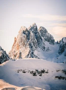 Sharp mountain peaks covered by snow at sunset, Dolomites, Italy Stock Photos