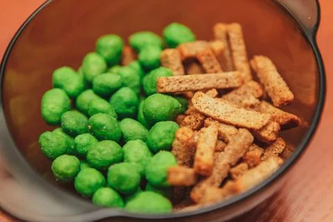 Sharp nuts with wasabi. Crackers with spices. Beer snacks. Stock Photos