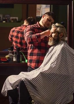 Sharp object near face and squirming distracts person holding it. Donate hair Stock Photos