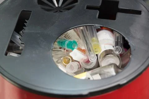 Sharp objects in red container for biohazard in operating room Stock Photos