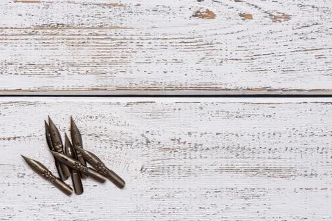 Sharp pen for calligraphy. light wood background. retro style Stock Photos