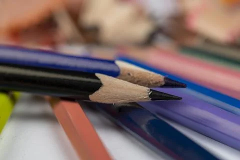 Sharp pencil of different colors on paper close-up Stock Photos