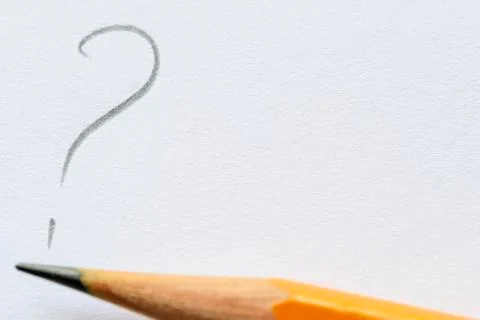 Sharp pencil by question mark on white paper Stockfoto's