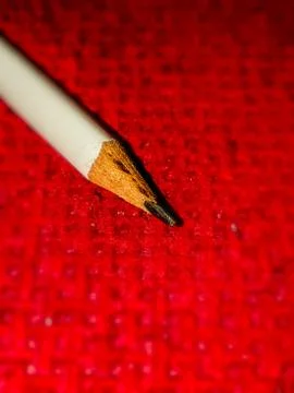 Sharp pencil on a red background Stock Photos