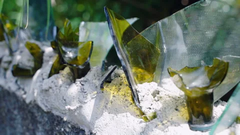 Sharp pieces of broken glass bottles and mirror on the top of concrete wall Stock Footage 305053020
