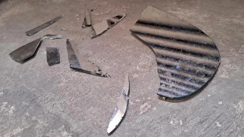 Sharp pieces of a broken mirror scattered on concrete floor Stock Photos