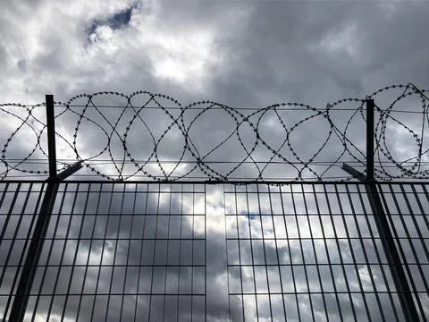 Sharp razor wire fence. Concept of refugee,prison, ,criminal, immigration, de Stock Photos