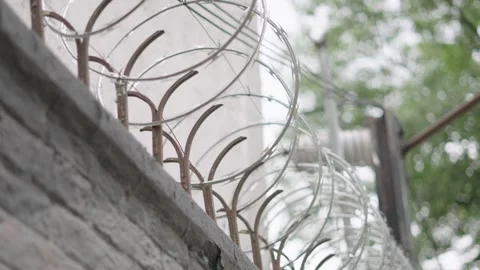 Sharp razor wire providing security on top of a concrete wall in mexico city 스톡 동영상 341981188