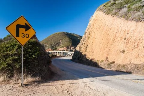 Sharp right turn and roadcut, USA highway, Western landscape Stock Photos