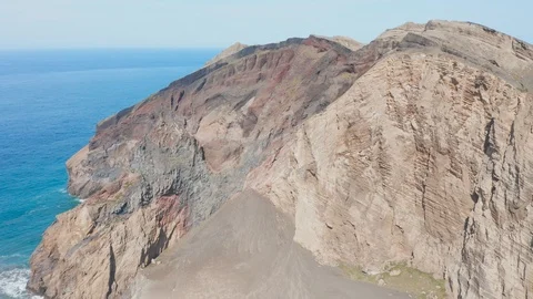 Sharp rocks above the Atlantic ocean. Aerial of Capelinhos volcano, Faial island Stock Footage 119599558