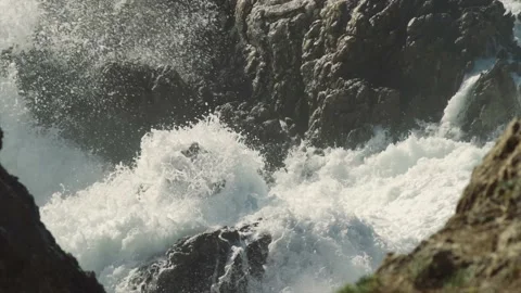 Sharp rocks covered with splashing waves Stock Footage 168776586