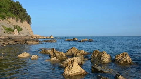 Sharp rocks jut out of the water Stock Footage 219573489