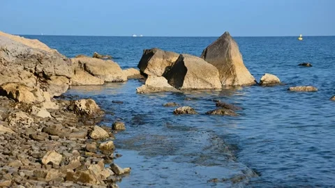 Sharp rocks jut out of the water Stock Footage 219574300