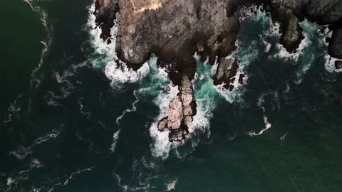Sharp rocks on the ocean coastline from high above drone top down view Stock Footage 236741298