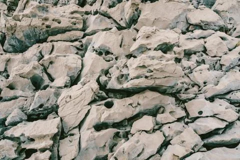 Sharp rocks with voids and holes on the Adriatic coast in Montenegro. 库存照片