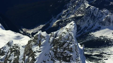 Sharp rocky mountain peak covered with winter snow Stock Footage 340962763