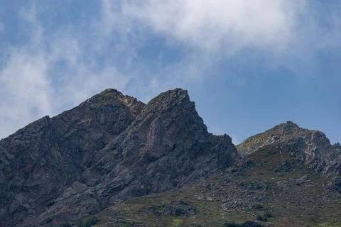 Sharp Rocky Mountain Peak Under Blue Sky Stock Photos