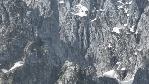 Sharp rocky mountains landscape, close up telephoto parallax aerial view. Stock Footage 251998078