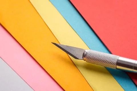 Sharp scalpel on papers Stock Photos