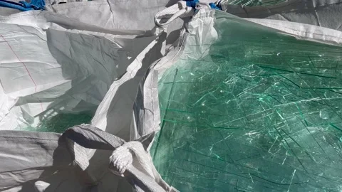 Sharp sheet glass waste in big white bags Stock Footage 235708943