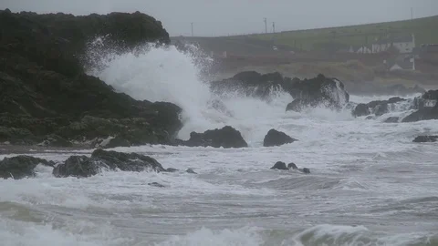 Sharp shillouette rocks with waves crashing over them Stock Footage 72482645
