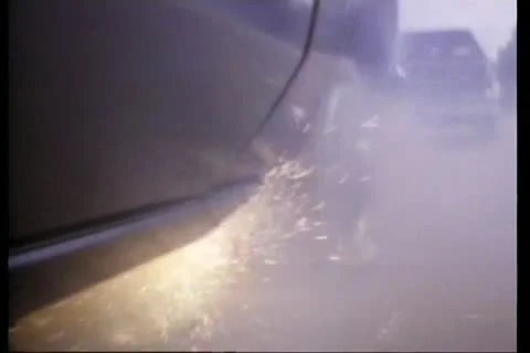 Sharp shooter aims at tire causing car to flip over Stock Footage 11345754