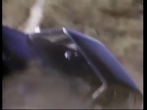 Sharp shooter aims at tire causing car to flip over Stock Footage 260247343