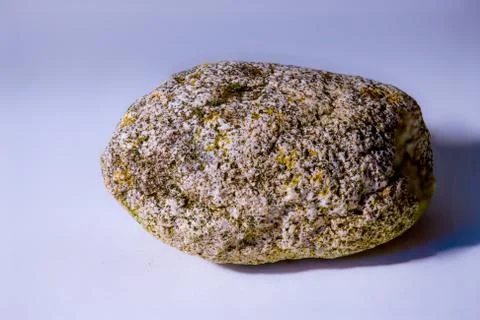 A sharp shot of a stone  with a blurred simple background Stock Photos